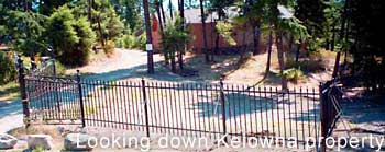 view down driveway from Kelown main house, note wrought iron crafts fence and gate
